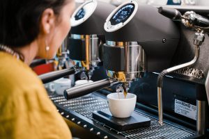 Barista pulling a shot on Sanremo Café Racer during a training session