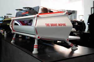 Sanremo Cafe Racer in white "The Brave Inspire" edition at coffee industry event, rear side view