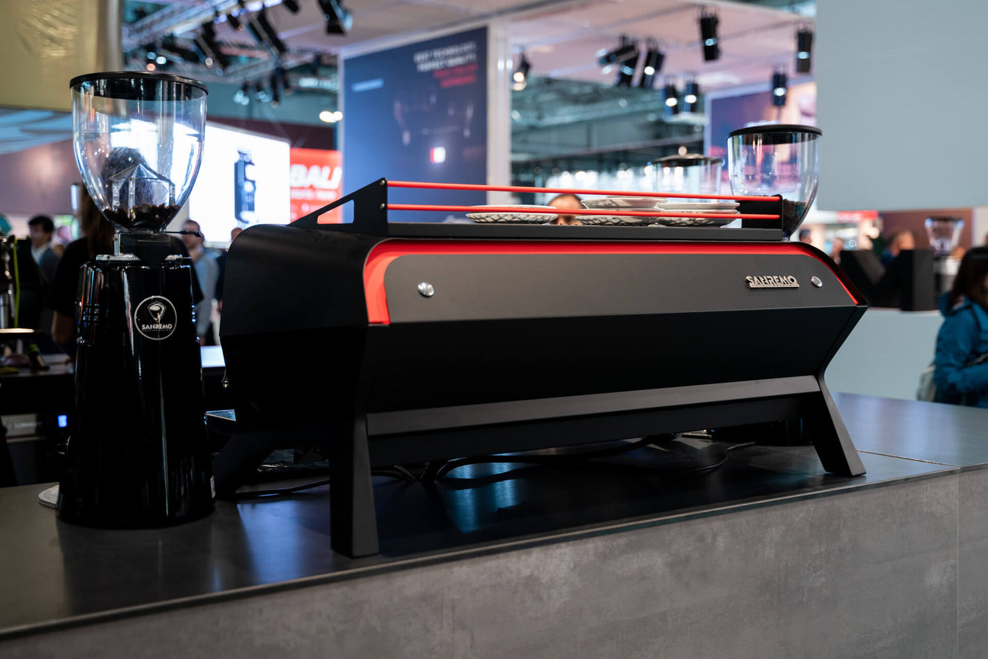 Sanremo F18 3 groups black and red commercial espresso machine rear view, at a coffee industry event