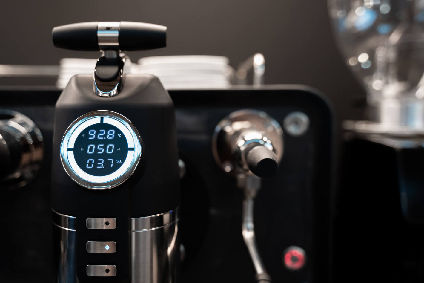 Sanremo Opera commercial espresso machine in black, close-up to the group head digital system display, providing visibility of all coffee extraction parameters