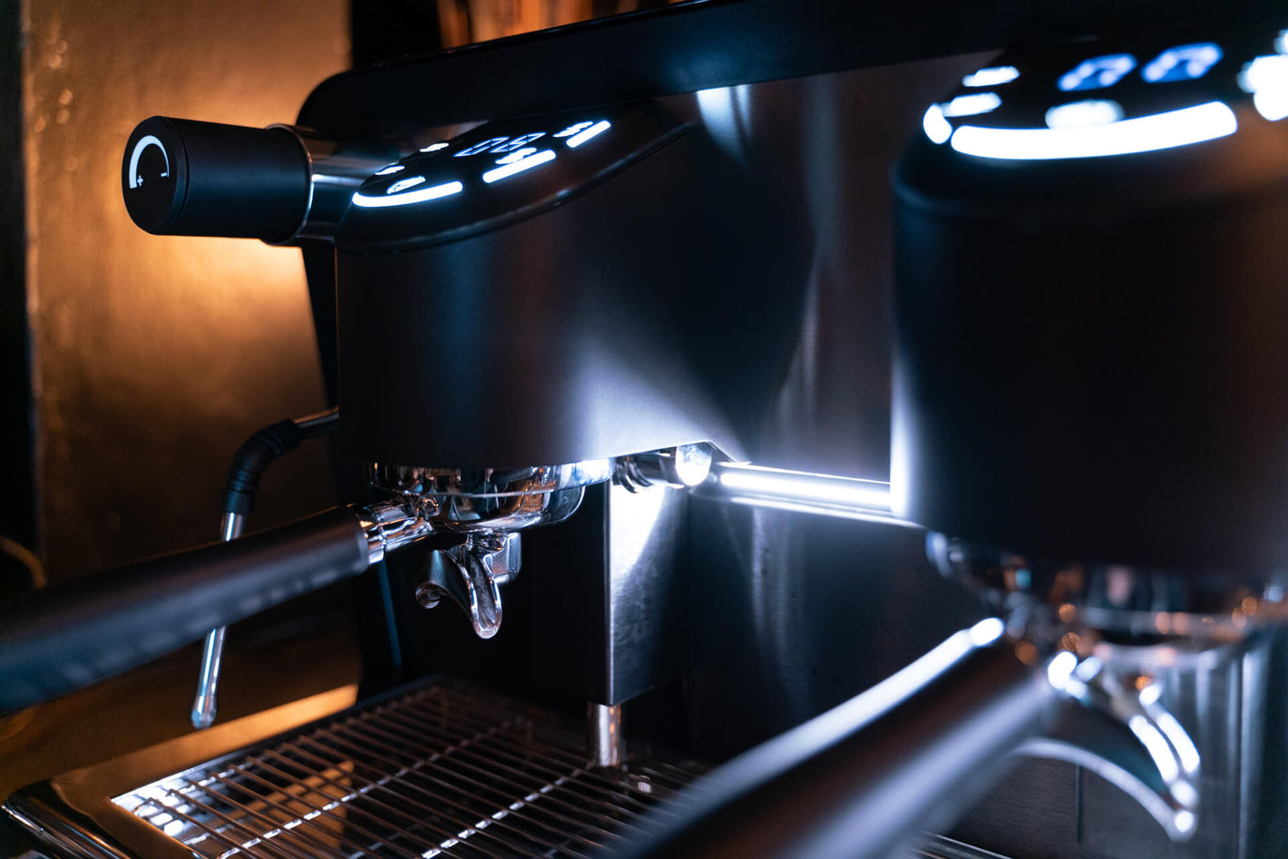 Sanremo F18 coffee espresso machine close-up to a group head display, portafilter and LEDs lit
