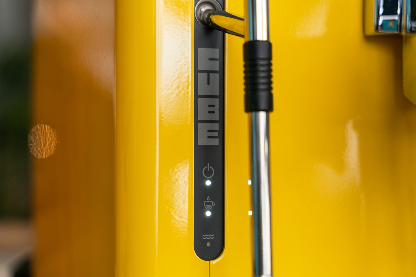 Sanremo CUBE espresso machine for home baristas in yellow, close-up to on/off, temperature and water level alarm led indicators