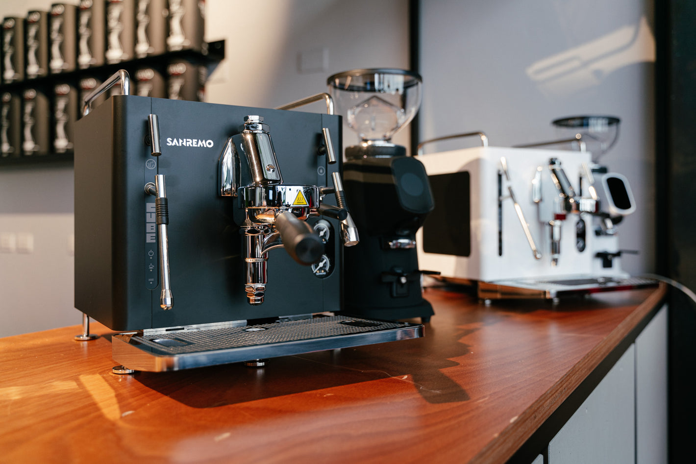 Sanremo CUBE espresso machines combined with Sanremo Allground grinders in black and white for home baristas