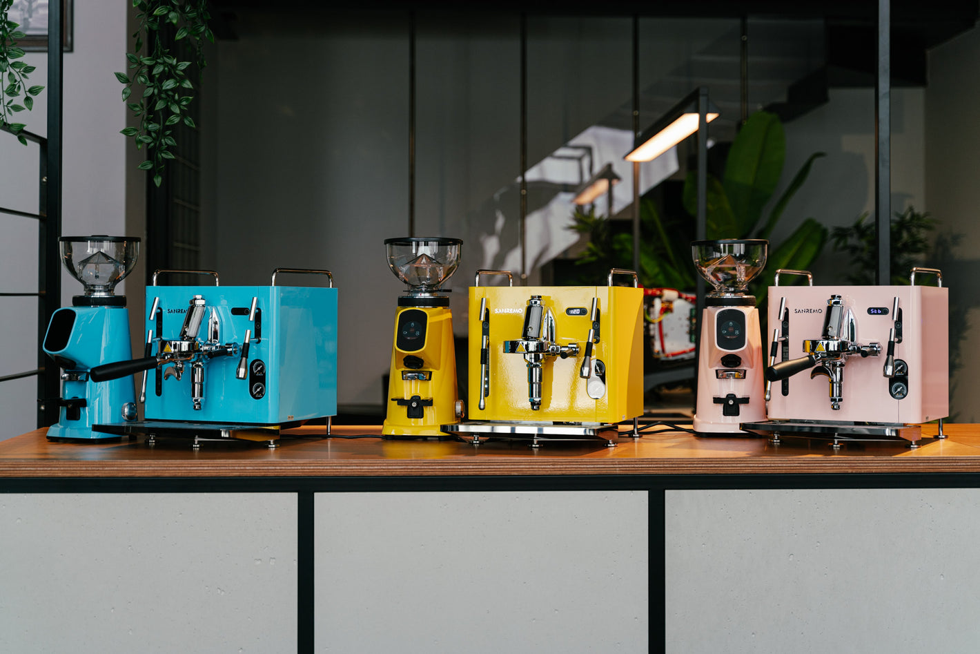 Sanremo CUBE espresso machines combined with Sanremo Allground grinders in blue, yellow and pink for home baristas