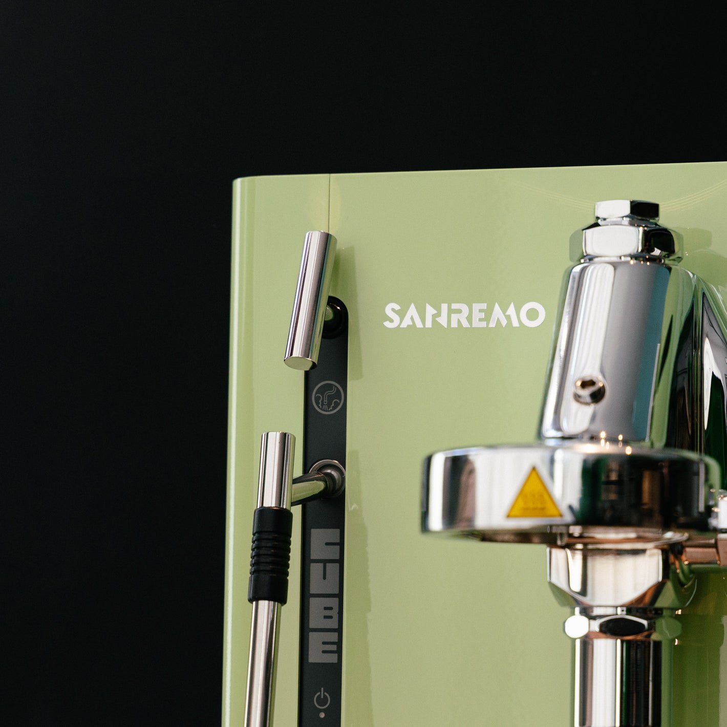 Sanremo CUBE espresso machine for home baristas in green, close-up to group head and logo