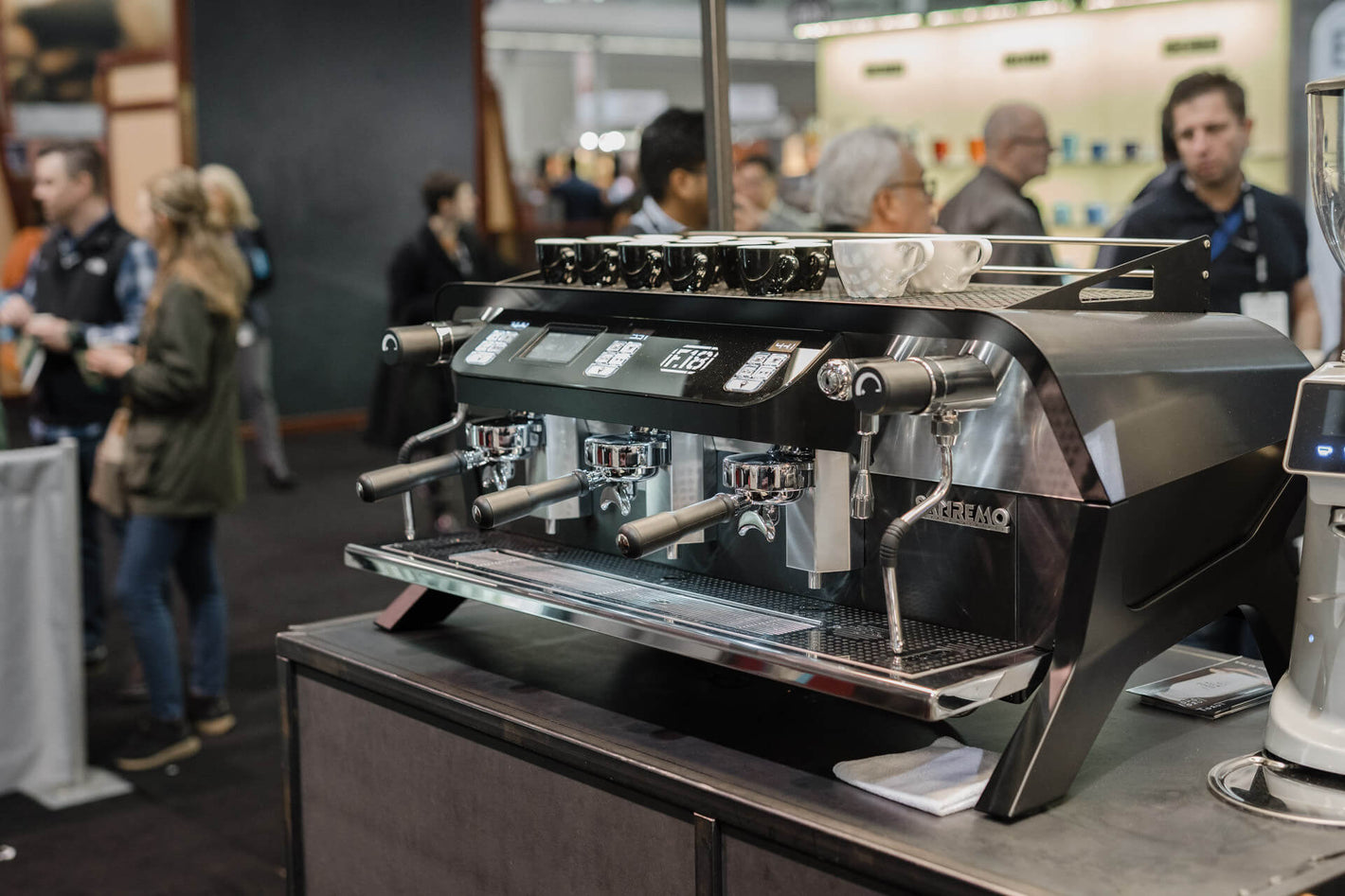 Sanremo F18 3 groups black commercial espresso machine 3/4 view, at the Sanremo pop-up café booth
